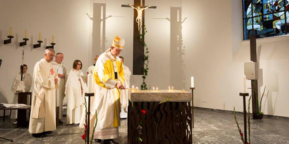 Kardinal Woelki entzündet auf dem Altar die Wachsdochte mit Weihrauch