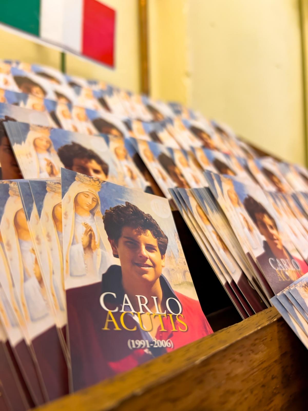 Assisi, Italy - September 9, 2023: Little posters of Carlo Acutis with the prayer to him on the back side