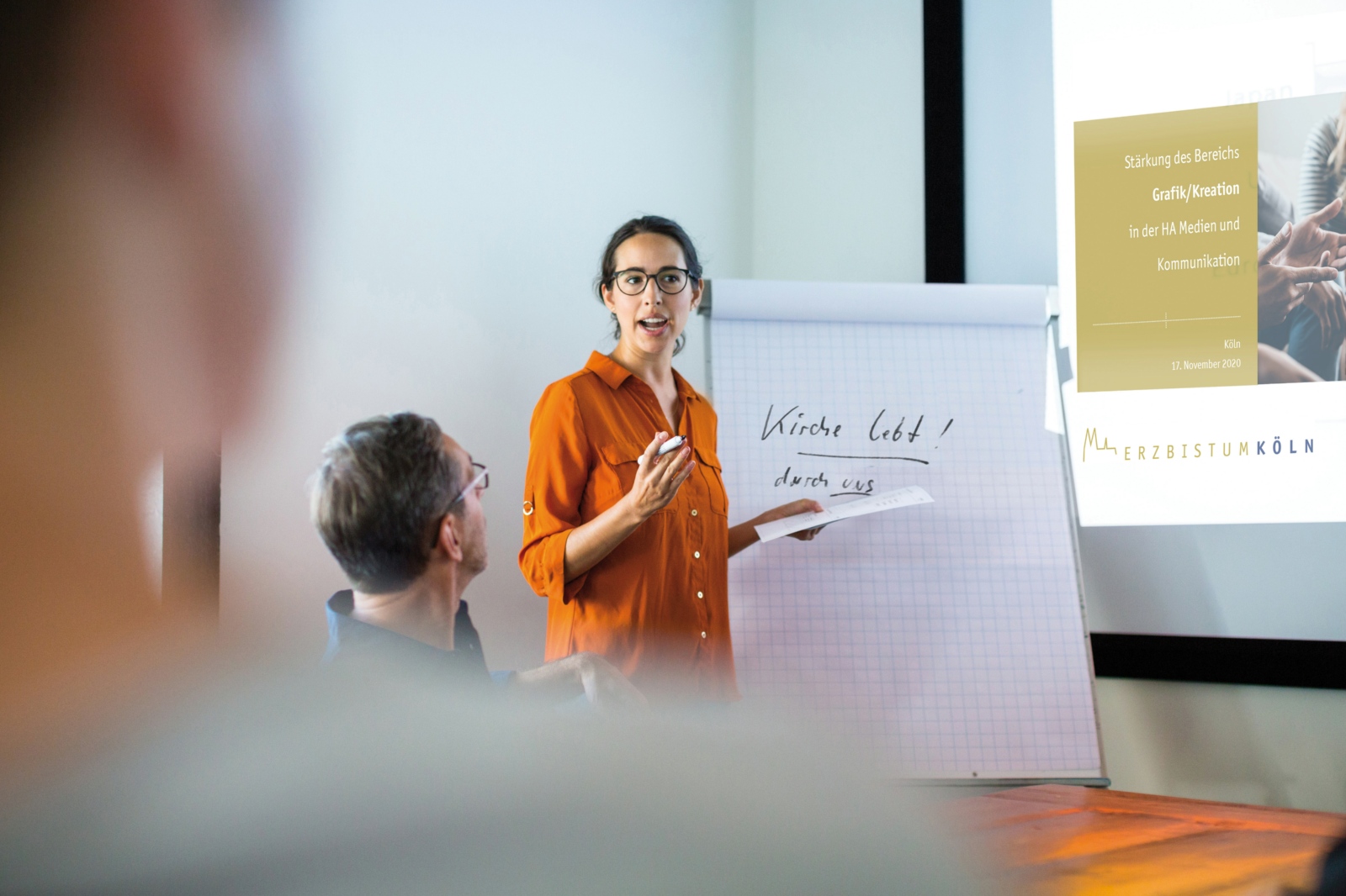 Businesswoman giving presentation to colleagues in conference room. Female entrepreneur explaining new business strategy to colleagues at boardroom.