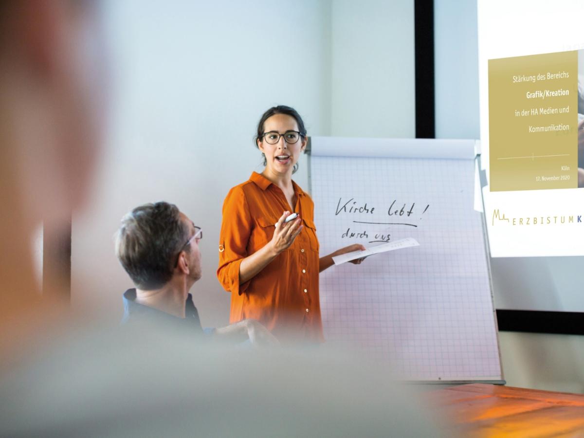 Businesswoman giving presentation to colleagues in conference room. Female entrepreneur explaining new business strategy to colleagues at boardroom.